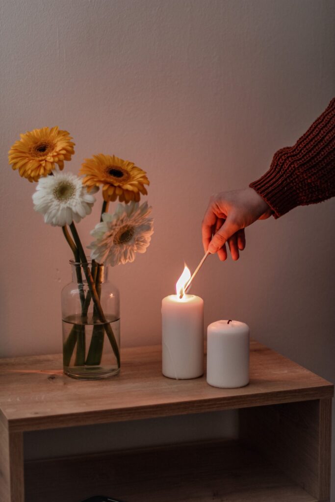 someone lighting a candle