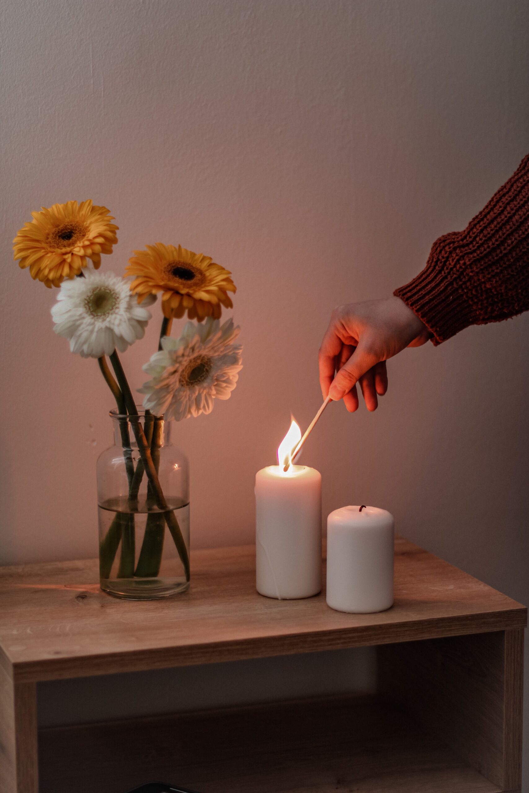 someone lighting a candle