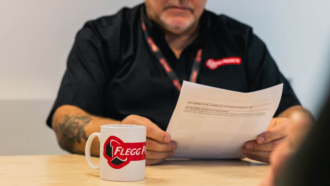 Flegg employee reading risk assessment document