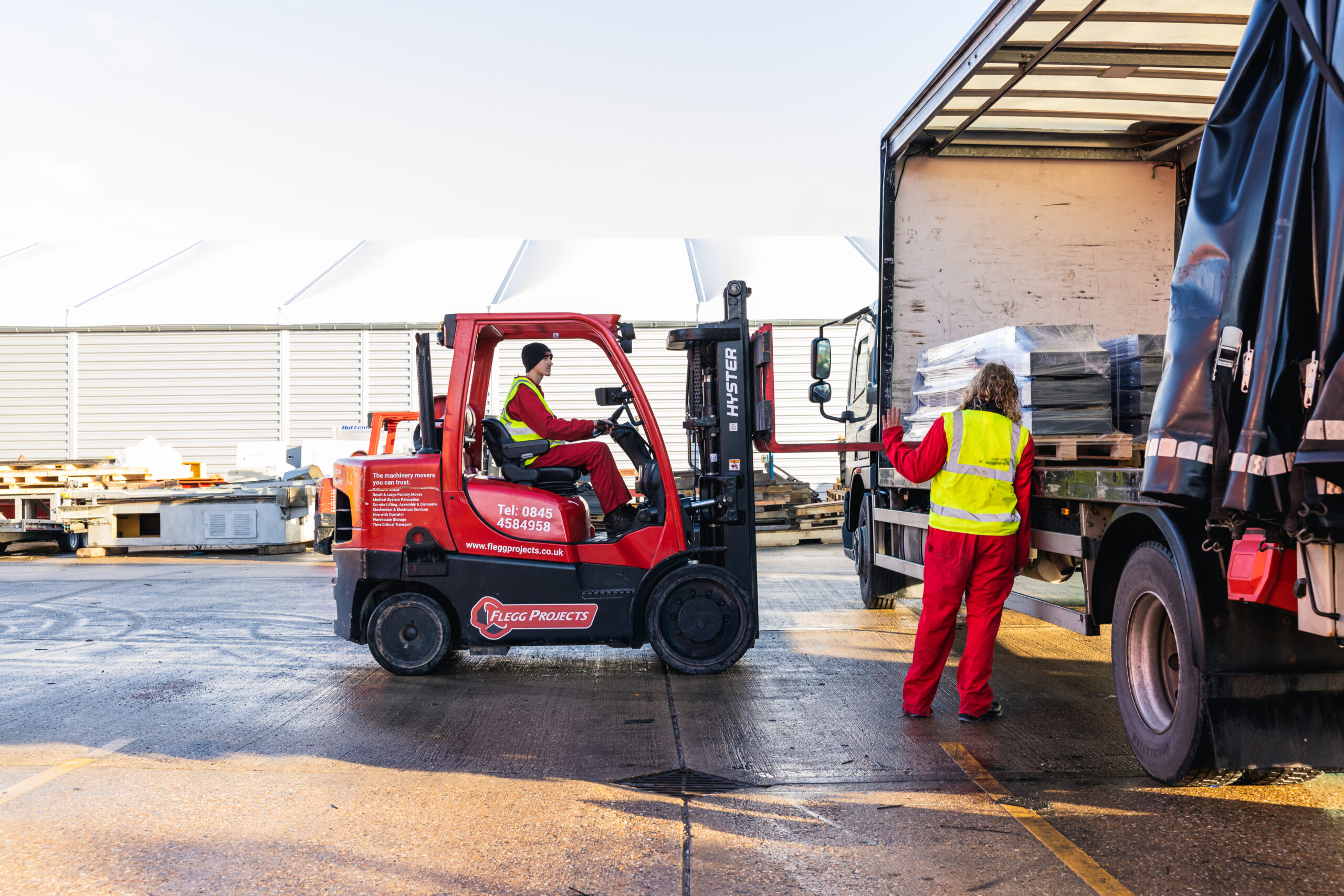 forklift taking equipment off truck