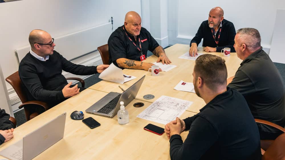 Back office staff meeting around table