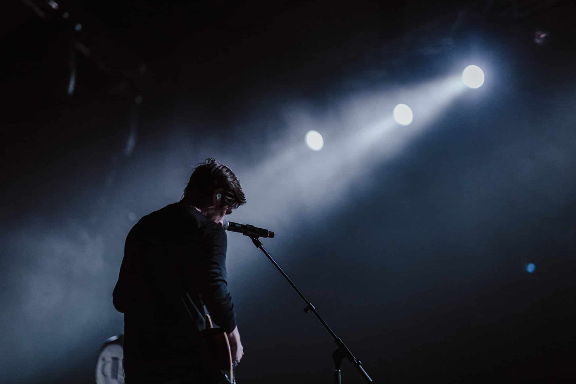 Musician behind microphone