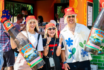 People wearing hats with noodles and smiling